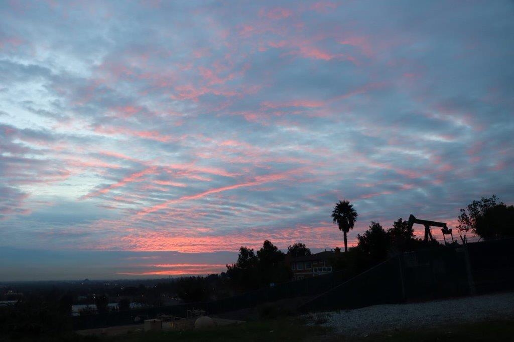 A sunset over a city

Description automatically generated