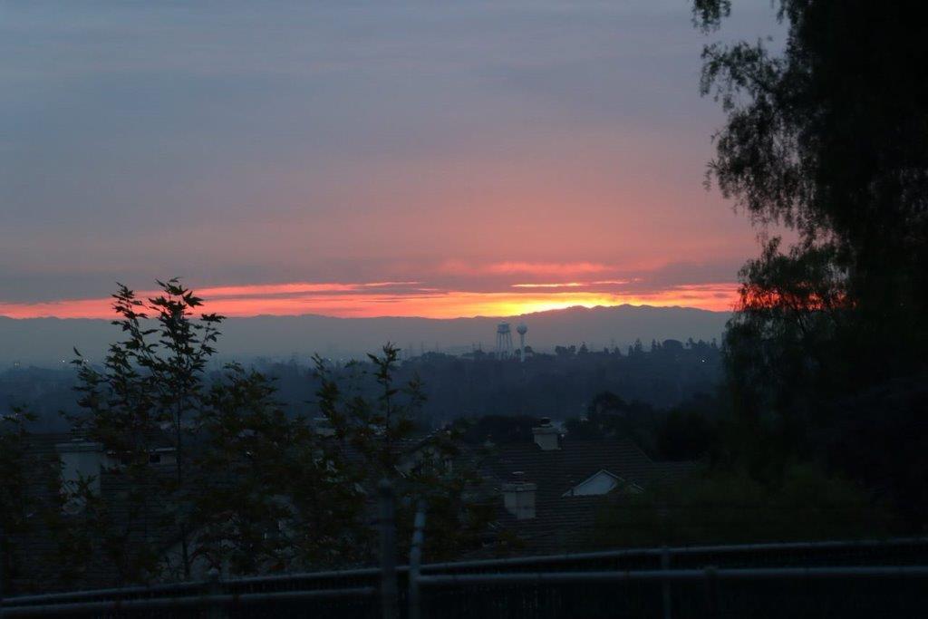 A sunset over a city

Description automatically generated