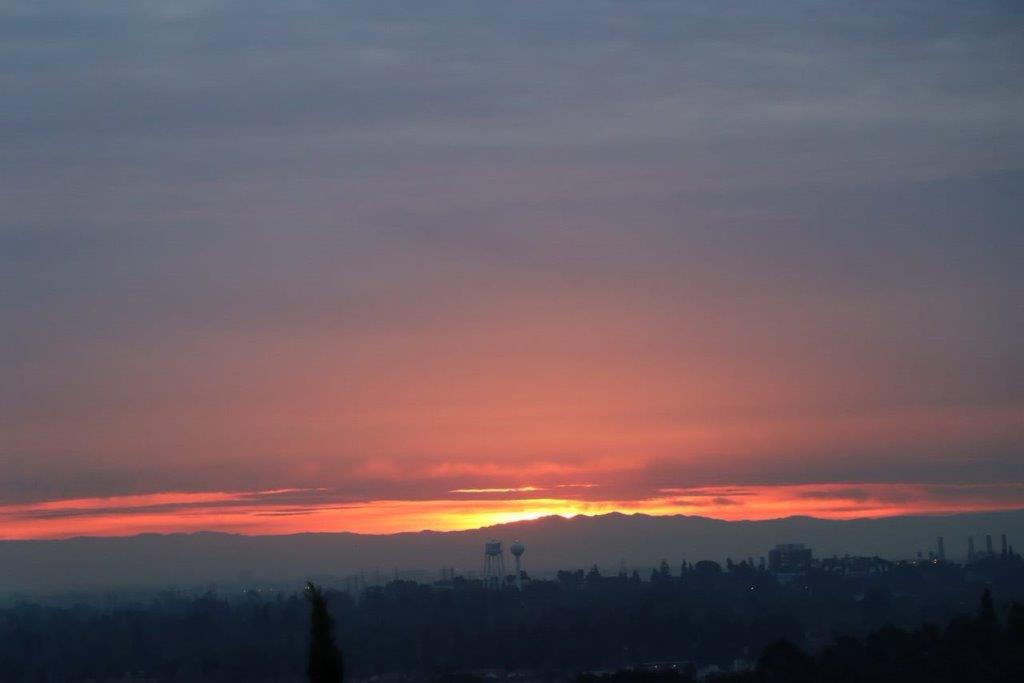 A sunset over a city

Description automatically generated