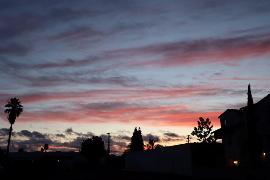 A sunset over a city

Description automatically generated