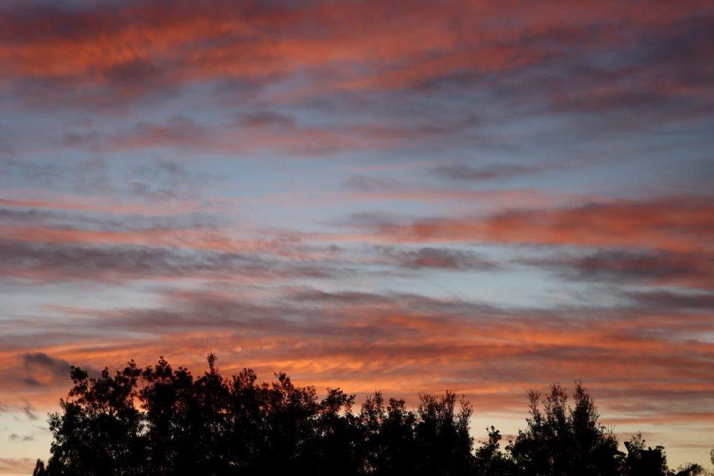 A sunset with clouds in the sky

Description automatically generated