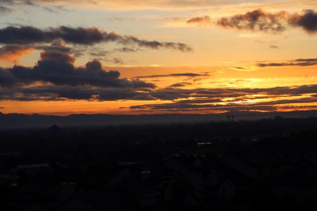 A sunset over a city

Description automatically generated