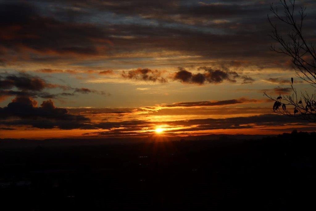 A sunset over a city

Description automatically generated