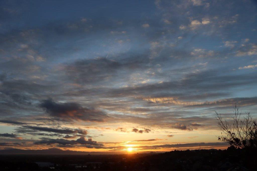 A sunset over a city

Description automatically generated