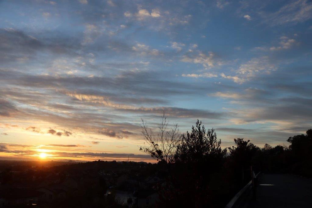 A sunset over a city

Description automatically generated