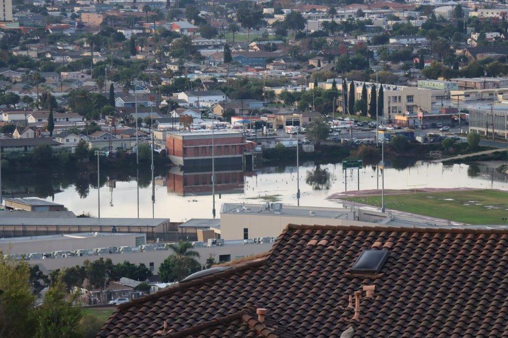 A flooded city with buildings and a river

Description automatically generated with medium confidence