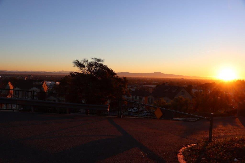 A sunset over a city

Description automatically generated