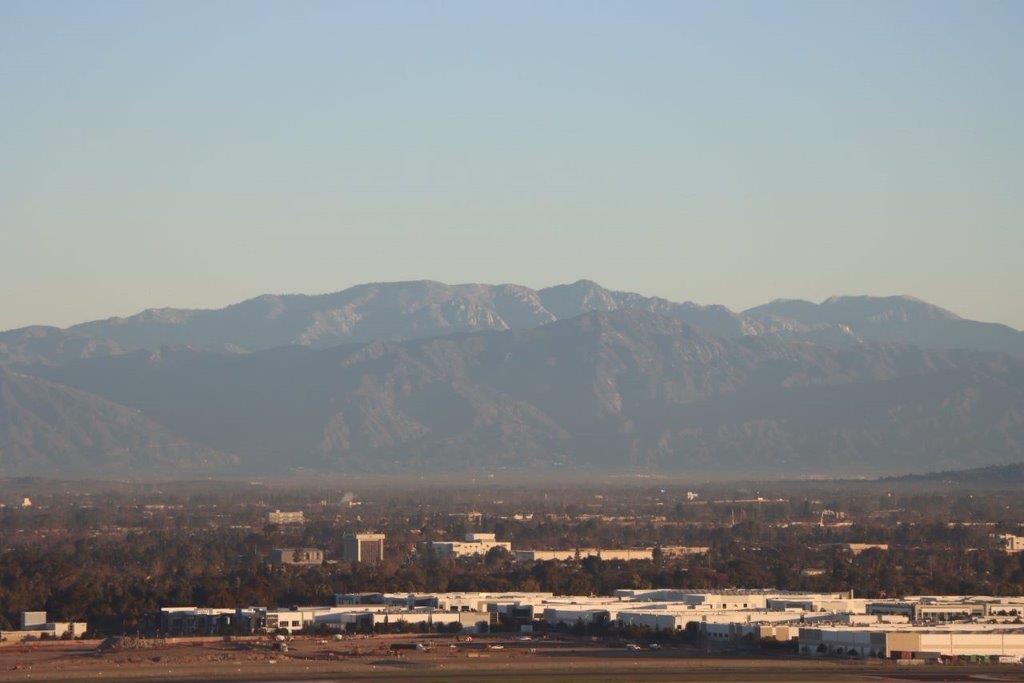 A city with mountains in the background

Description automatically generated