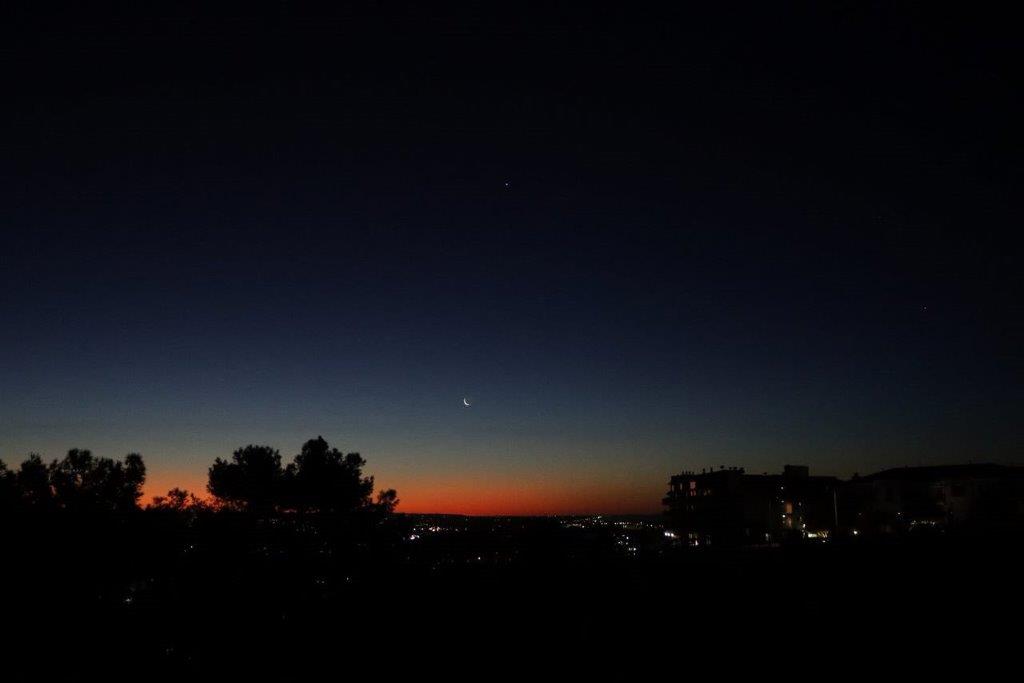 A sunset over a city

Description automatically generated