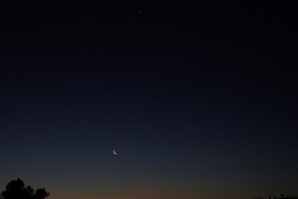 A moon in the sky

Description automatically generated