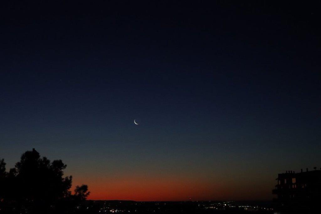 A moon in the sky at night

Description automatically generated