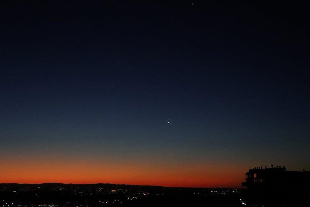 A moon in the sky

Description automatically generated