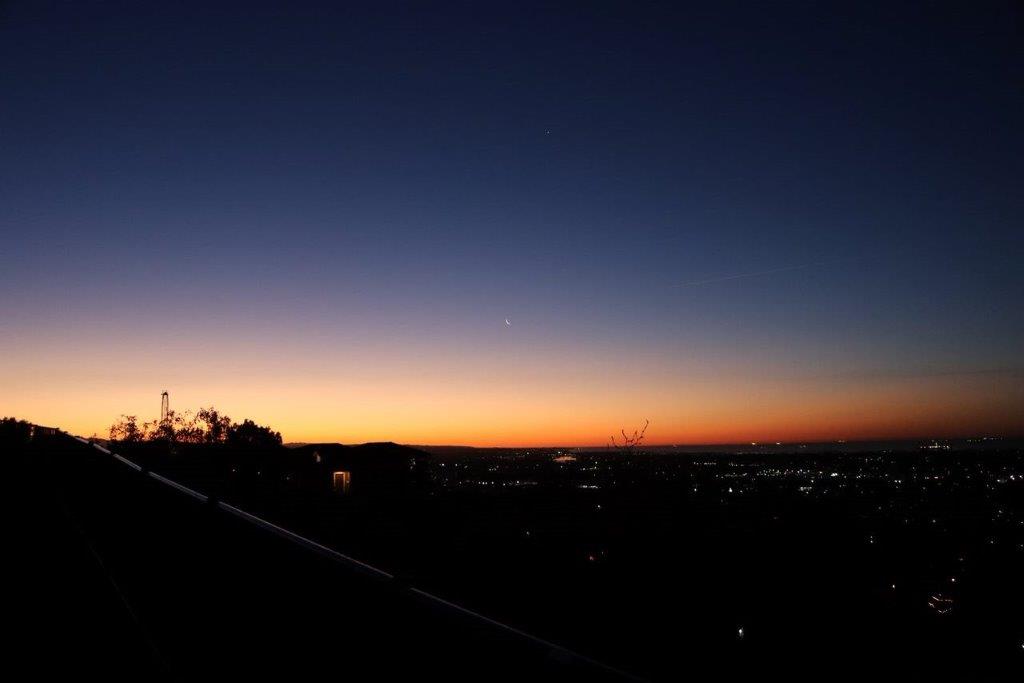 A sunset over a city

Description automatically generated