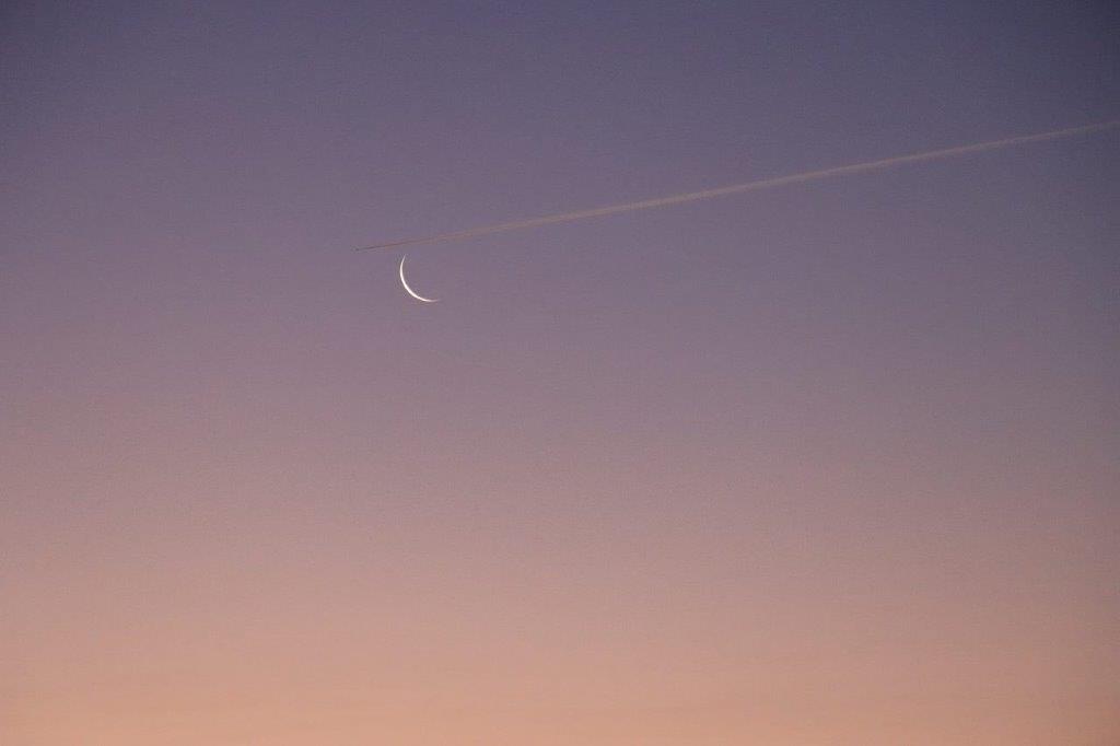 A moon in the sky

Description automatically generated