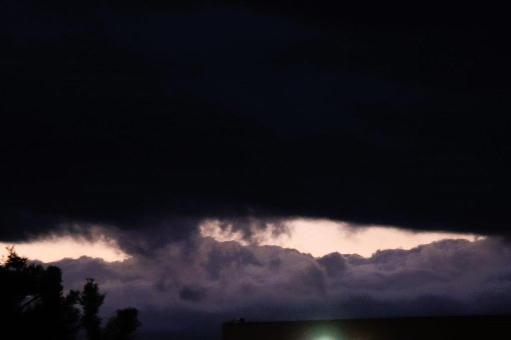 A dark sky with clouds

Description automatically generated
