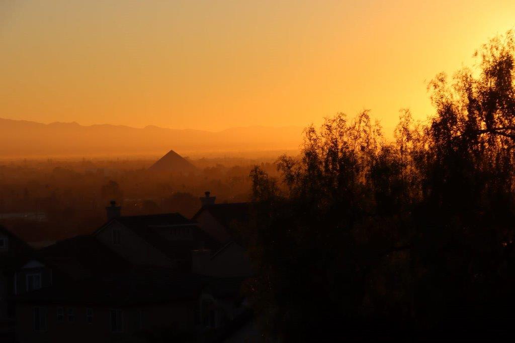 A sunset over a city

Description automatically generated