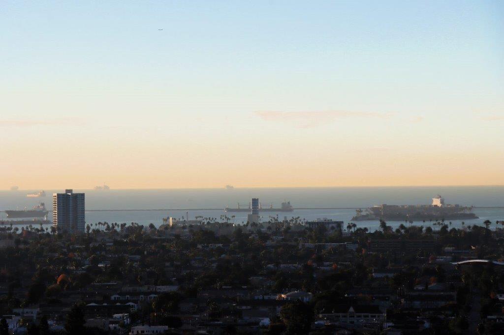 A city with a body of water in the background

Description automatically generated