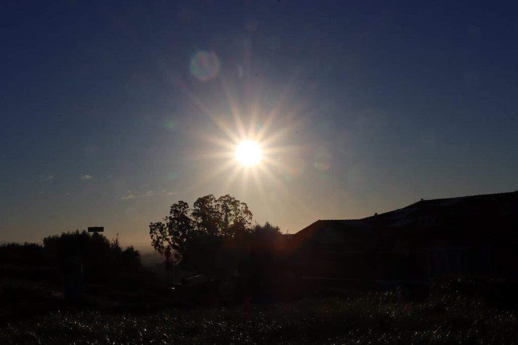 The sun shining through the sky

Description automatically generated