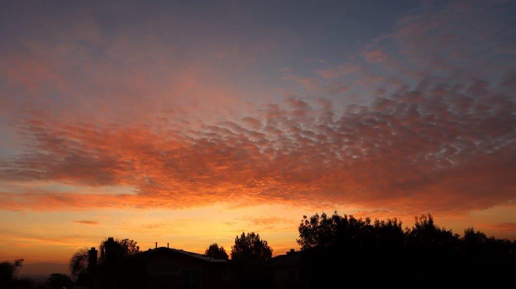 A sunset with clouds in the sky

Description automatically generated