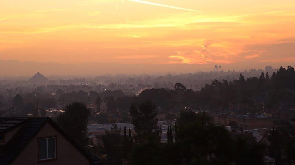 A view of a city at sunset

Description automatically generated