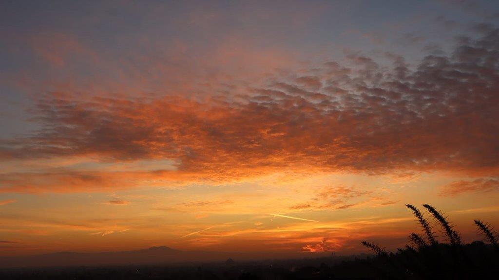 A sunset with clouds in the sky

Description automatically generated