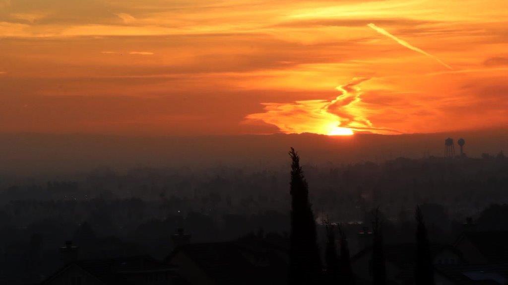 A sunset over a city

Description automatically generated