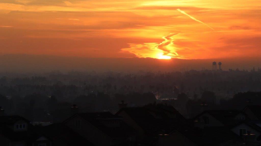 A sunset over a city

Description automatically generated