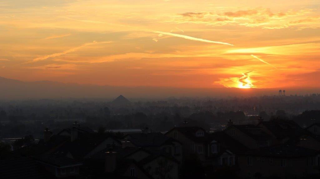 A sunset over a city

Description automatically generated