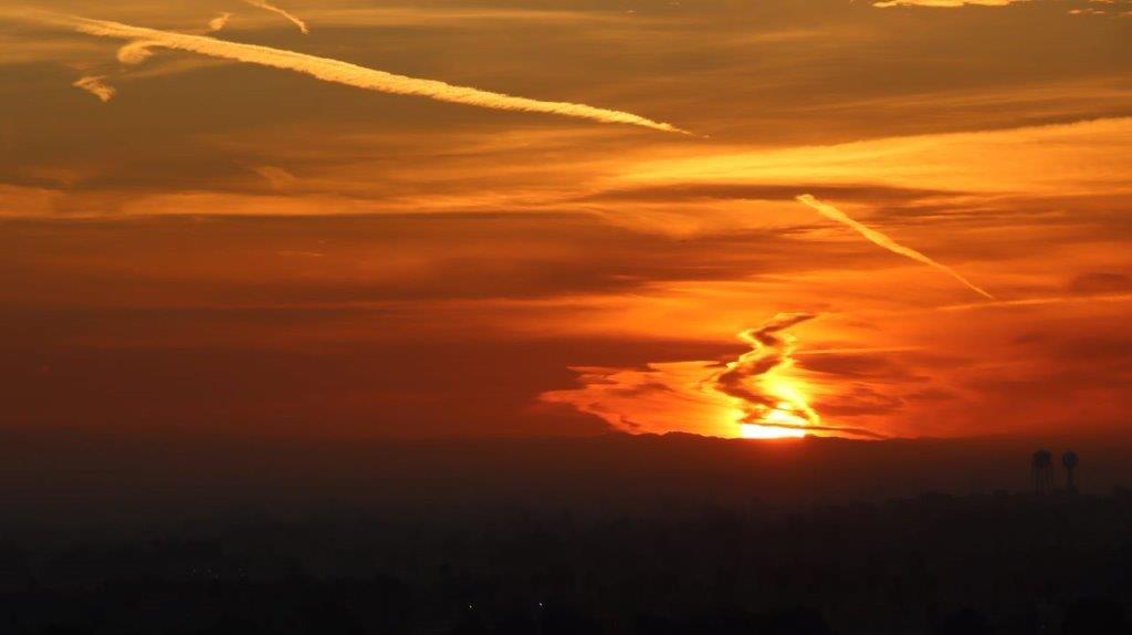 A sunset with a few jets in the sky

Description automatically generated with medium confidence