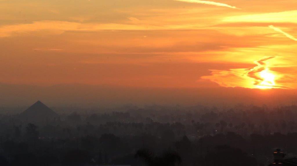 A sunset over a city

Description automatically generated