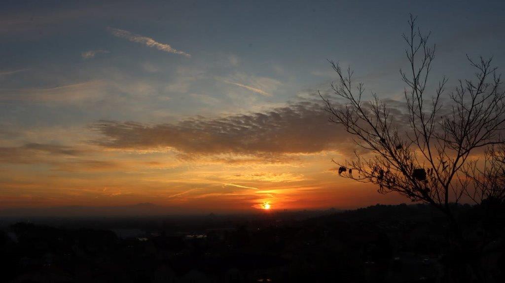 A sunset over a hill

Description automatically generated