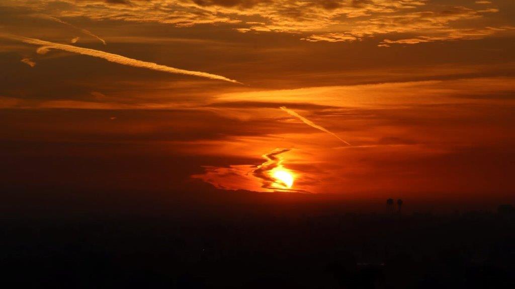 A sunset with clouds and a trail

Description automatically generated with medium confidence