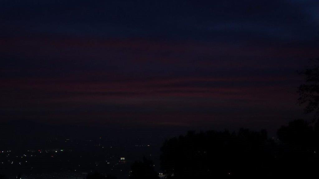 A dark sky with clouds

Description automatically generated