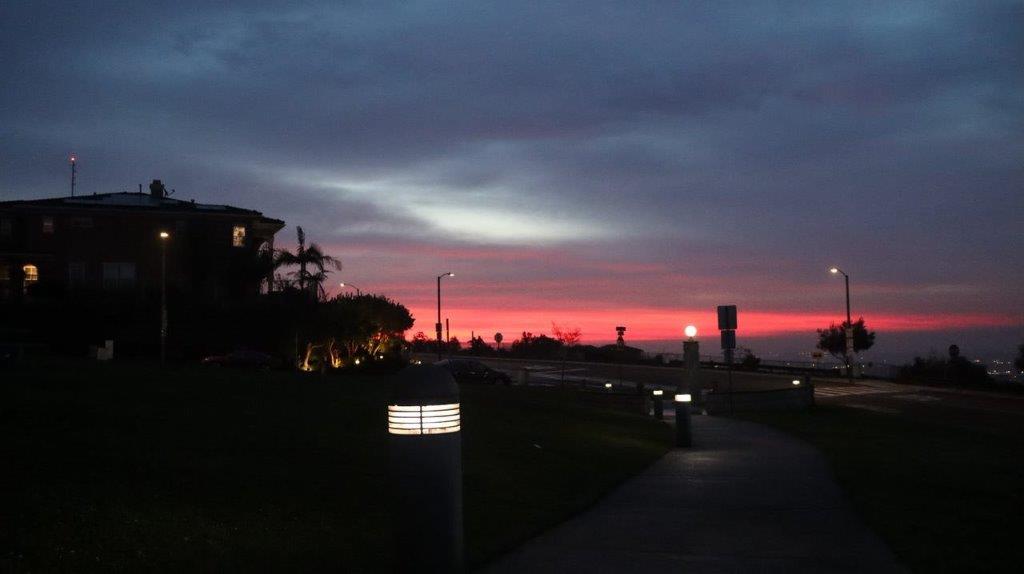A sunset over a road

Description automatically generated