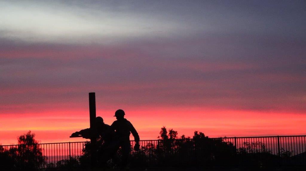 A silhouette of a couple of men

Description automatically generated