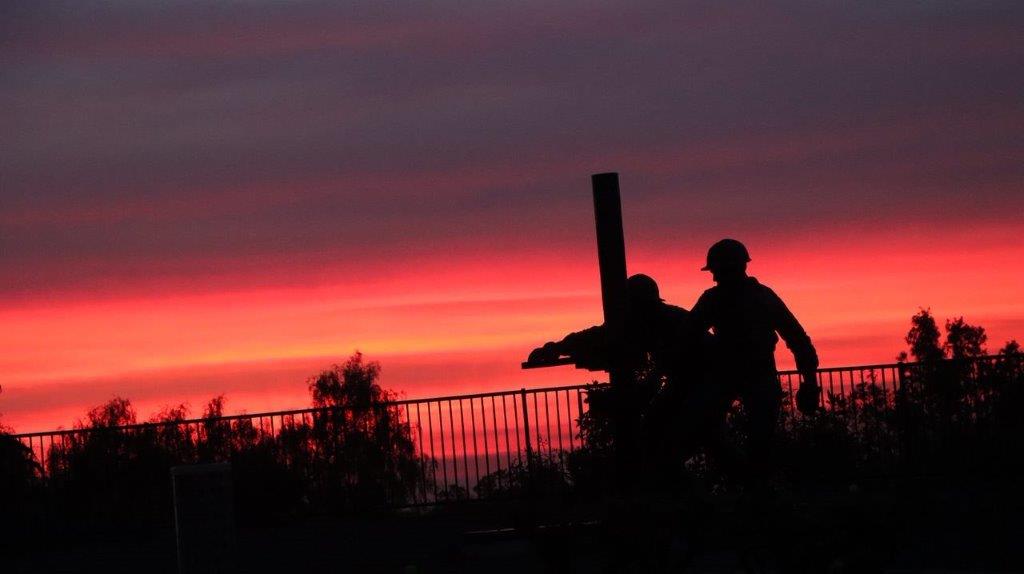 A silhouette of a couple of men

Description automatically generated