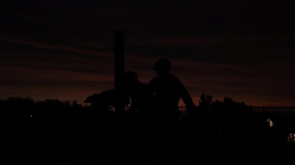 A silhouette of a couple of men

Description automatically generated