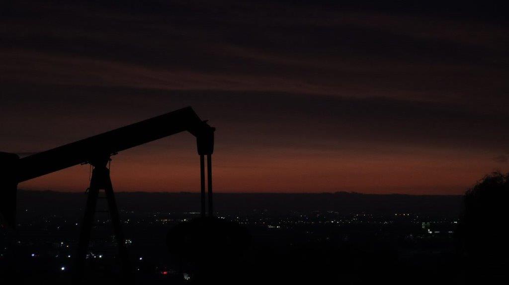 A silhouette of a machine at night

Description automatically generated
