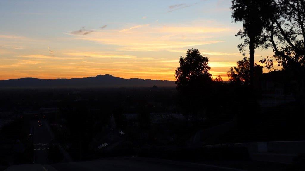A sunset over a city

Description automatically generated
