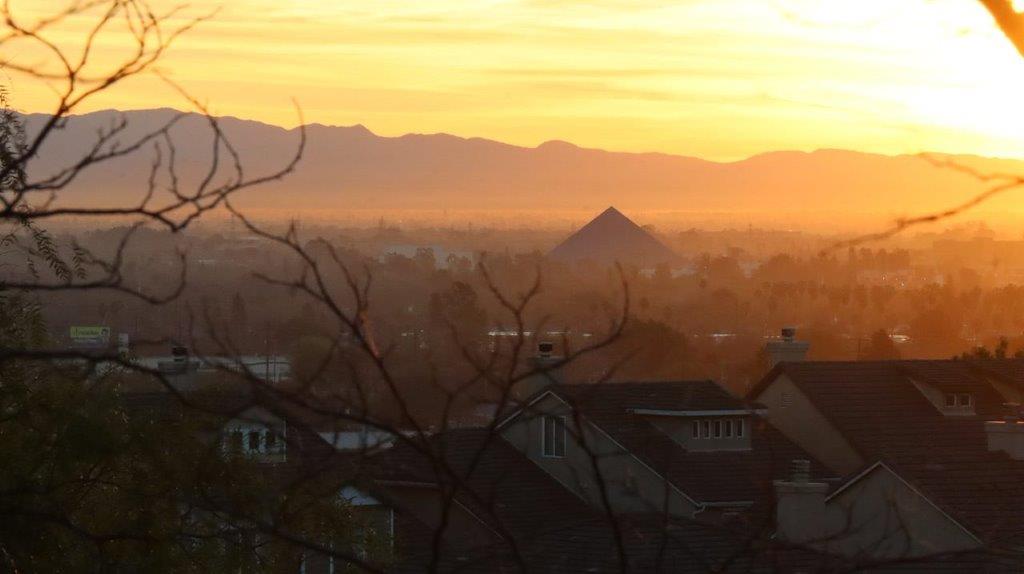 A sunset over a city

Description automatically generated