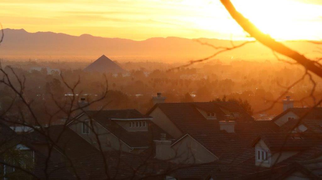 A sunset over a city

Description automatically generated