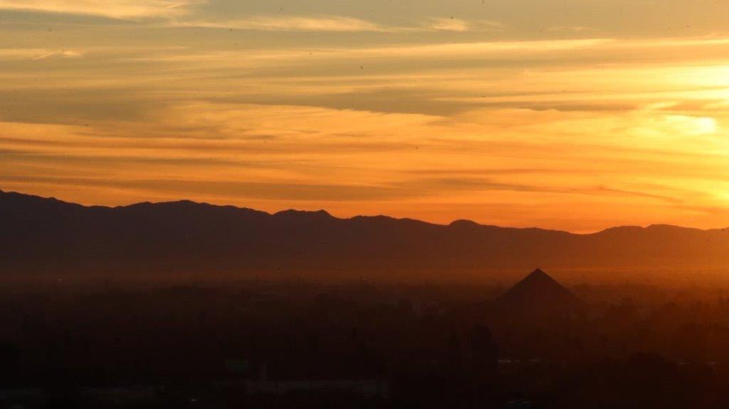 A sunset over a city

Description automatically generated