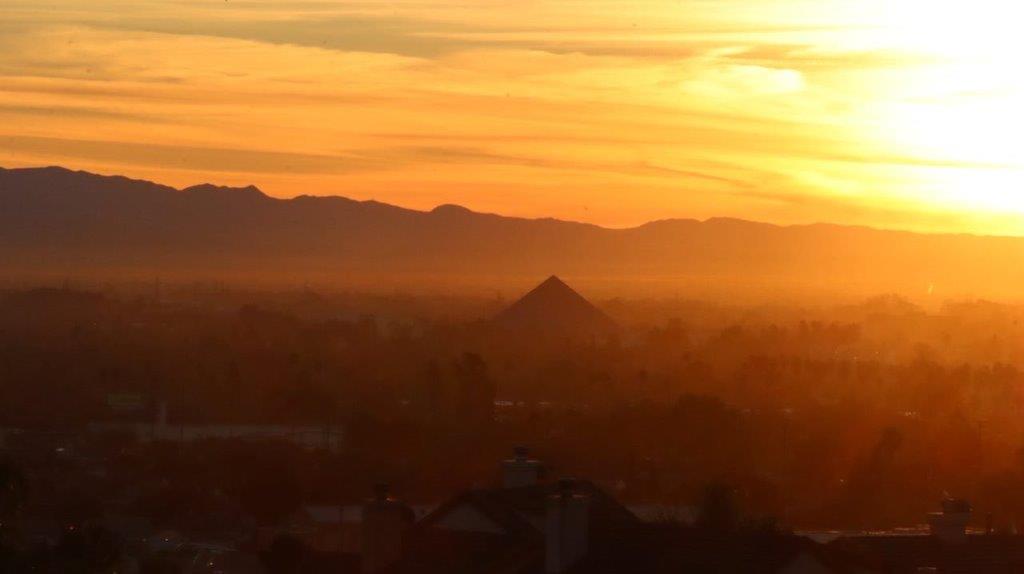 A sunset over a city

Description automatically generated