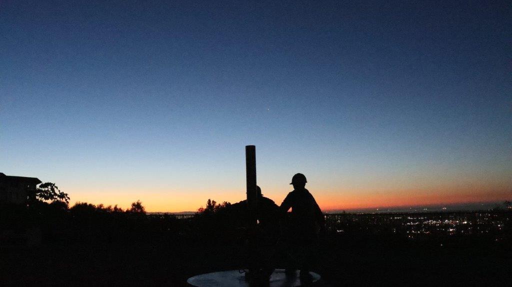 A silhouette of a person and a pole

Description automatically generated