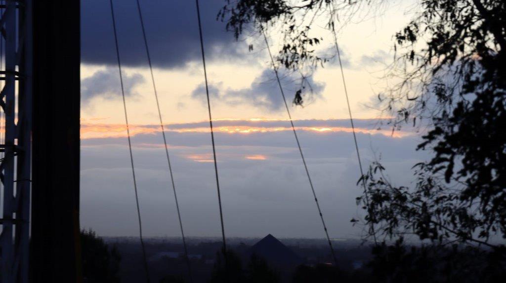 A view of a city from a power line

Description automatically generated