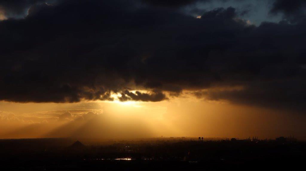 Sun shining through the clouds

Description automatically generated