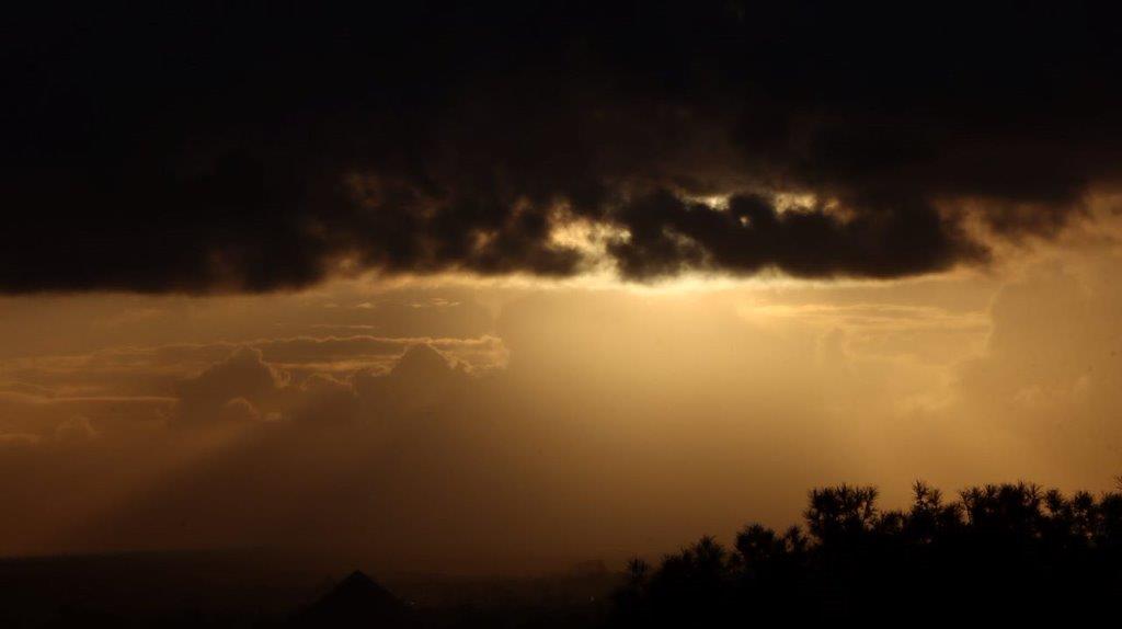 A sun shining through clouds

Description automatically generated
