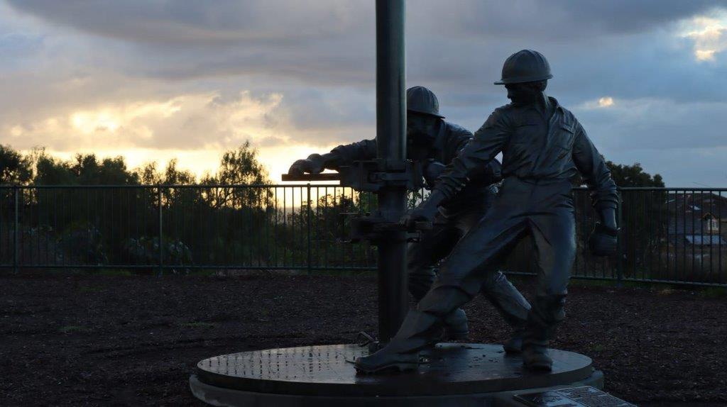 A statue of men in hard hats

Description automatically generated