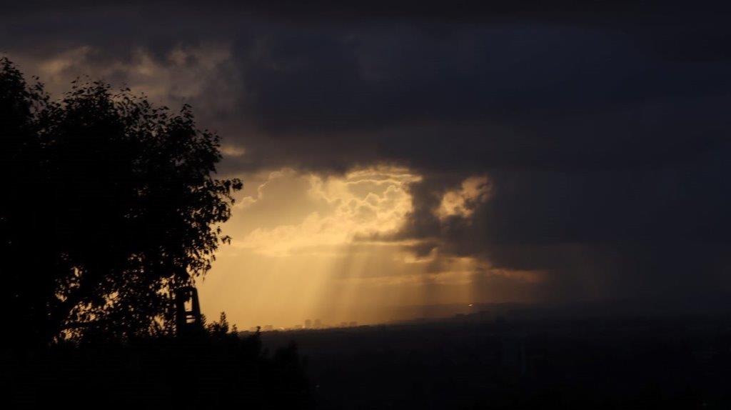 Sun shining through the clouds

Description automatically generated