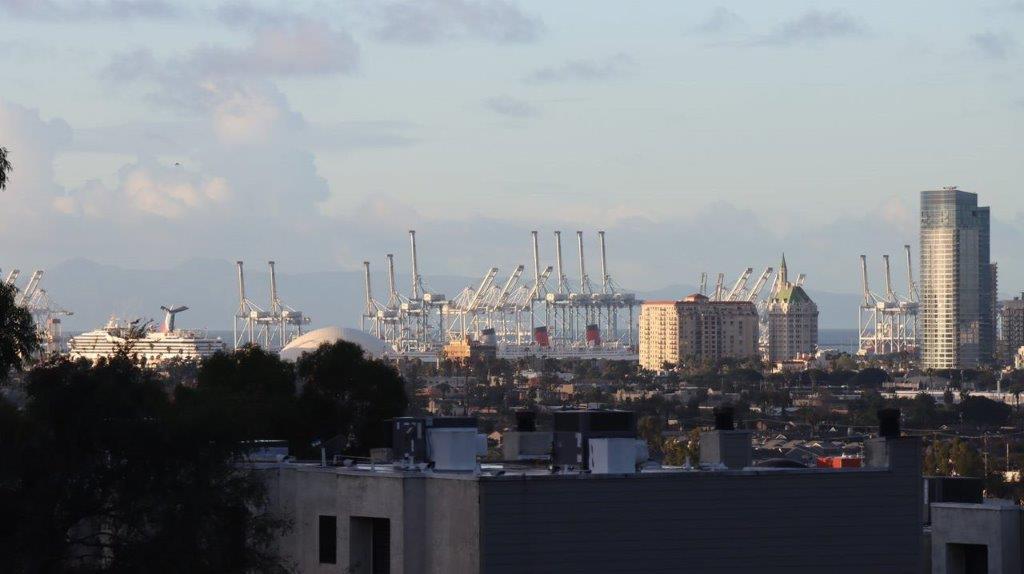 A view of a city with cranes

Description automatically generated